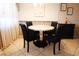 Charming dining area with a round table, chairs, and decorative wall art at 1838 Sunny Dr # D35, Bradenton, FL 34207