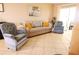 Inviting living room with tile floors, neutral walls, and comfortable seating at 1838 Sunny Dr # D35, Bradenton, FL 34207