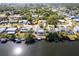 Waterfront home featuring a screened in lanai, private dock on the canal, and mature trees at 18422 Burkholder Cir, Port Charlotte, FL 33948