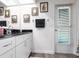 Bathroom featuring a modern vanity with double sinks, ample lighting, and elegant wall decor at 18422 Burkholder Cir, Port Charlotte, FL 33948
