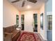 Bright foyer with a bench, red rug and glass panels providing natural light at 18422 Burkholder Cir, Port Charlotte, FL 33948