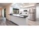 Modern kitchen with stainless steel appliances and a sleek island countertop at 18422 Burkholder Cir, Port Charlotte, FL 33948