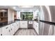 Updated kitchen featuring stainless steel appliances and white cabinets at 18422 Burkholder Cir, Port Charlotte, FL 33948