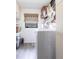Functional laundry room featuring a washing machine, shelving for supplies, and natural light at 18422 Burkholder Cir, Port Charlotte, FL 33948