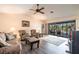 Spacious living room with ceiling fan and sliding glass doors leading to the pool at 18422 Burkholder Cir, Port Charlotte, FL 33948