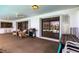 Outdoor patio featuring a grill, comfortable seating, and a bar area, perfect for entertaining at 18422 Burkholder Cir, Port Charlotte, FL 33948