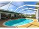 Inviting screened-in pool with an extended patio, perfect for relaxation and outdoor enjoyment at 18422 Burkholder Cir, Port Charlotte, FL 33948