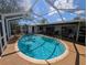 Inviting screened-in pool area perfect for relaxation and outdoor entertainment at 18422 Burkholder Cir, Port Charlotte, FL 33948