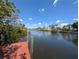 Picturesque canal view with docks, boat lifts, and lush greenery, highlighting waterfront living at 18422 Burkholder Cir, Port Charlotte, FL 33948