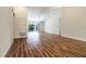 Open-concept living room with wood floors, vaulted ceilings, ceiling fan, and sliding glass doors leading to the backyard at 1871 Waltrip St, North Port, FL 34287