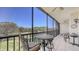 Screened lanai with outdoor dining set, providing a serene space to relax and enjoy the view at 1935 Gulf Of Mexico Dr # G7-402, Longboat Key, FL 34228