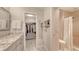 Elegant bathroom featuring a marble countertop, vanity, closet, and walk-in shower with modern fixtures at 1935 Gulf Of Mexico Dr # G7-402, Longboat Key, FL 34228