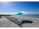 A perfect beach with plenty of beach chairs and blue sky at 1935 Gulf Of Mexico Dr # G7-402, Longboat Key, FL 34228
