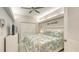 Well-lit bedroom features a ceiling fan, closet, coastal decor, and a comfortable bed with decorative pillows at 1935 Gulf Of Mexico Dr # G7-402, Longboat Key, FL 34228