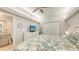 Bright bedroom with a ceiling fan, closet, TV, and a view leading into the adjacent bathroom at 1935 Gulf Of Mexico Dr # G7-402, Longboat Key, FL 34228