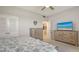 Bright bedroom featuring a ceiling fan, closet, and stylish dressers, creating a cozy and functional space at 1935 Gulf Of Mexico Dr # G7-402, Longboat Key, FL 34228