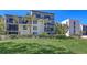Multi-story condo building surrounded by lush palm trees and well-maintained landscaping at 1935 Gulf Of Mexico Dr # G7-402, Longboat Key, FL 34228