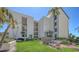 Beautiful condo building with manicured lawn and lush landscaping in a tropical setting at 1935 Gulf Of Mexico Dr # G7-402, Longboat Key, FL 34228