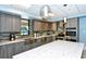 Modern kitchen with stainless steel appliances, granite countertops, and a stylish backsplash at 1935 Gulf Of Mexico Dr # G7-402, Longboat Key, FL 34228