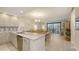 Open-concept kitchen features granite countertops, stainless appliances, and views of the dining and living area at 1935 Gulf Of Mexico Dr # G7-402, Longboat Key, FL 34228