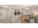 Charming eat-in kitchen with granite countertops, dining area, and modern stainless steel appliances at 1935 Gulf Of Mexico Dr # G7-402, Longboat Key, FL 34228