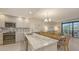 Modern kitchen features granite countertops, stainless steel appliances, mosaic backsplash and bright lighting at 1935 Gulf Of Mexico Dr # G7-402, Longboat Key, FL 34228