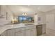 Kitchen with granite countertops, stainless appliances, and an open view of the dining and living area at 1935 Gulf Of Mexico Dr # G7-402, Longboat Key, FL 34228