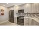 Well-equipped kitchen boasts stainless steel appliances, gray cabinets and granite countertops at 1935 Gulf Of Mexico Dr # G7-402, Longboat Key, FL 34228