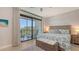 Bright main bedroom with a ceiling fan and access to a private balcony at 1935 Gulf Of Mexico Dr # G7-402, Longboat Key, FL 34228