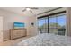 Relaxing bedroom offers access to the screened balcony and natural light at 1935 Gulf Of Mexico Dr # G7-402, Longboat Key, FL 34228