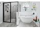 Bathroom featuring soaking tub, walk in shower, wainscoting and gray tile floor at 2259 Midnight Pearl Dr, Sarasota, FL 34240
