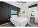 Bedroom with dark accent wall, modern ceiling fan, and hardwood style floor at 2259 Midnight Pearl Dr, Sarasota, FL 34240