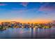 Waterfront city skyline at dusk with vibrant sunset colors reflecting on the water at 2259 Midnight Pearl Dr, Sarasota, FL 34240