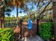 Fenced-in community playground with shade trees and play equipment at 2259 Midnight Pearl Dr, Sarasota, FL 34240