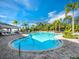 Community pool with plenty of lounge chairs and beautiful palm trees at 2259 Midnight Pearl Dr, Sarasota, FL 34240