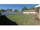 Spacious backyard with a patio seating area, bordered by a white privacy fence at 2316 Bradford St, Sarasota, FL 34231