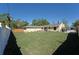 Large backyard with well-maintained lawn and a white fence for privacy at 2316 Bradford St, Sarasota, FL 34231