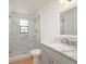 Modern bathroom with glass-enclosed shower featuring a handrail and marble sink at 2316 Bradford St, Sarasota, FL 34231