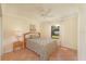 Light and airy bedroom offers a sunny window view, neutral walls, and tile flooring at 2316 Bradford St, Sarasota, FL 34231