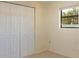 Small bedroom with a closet features a window view to the backyard at 2316 Bradford St, Sarasota, FL 34231