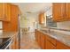 Kitchen with stainless steel appliances, wood cabinets, tile backsplash, and a granite countertop at 2316 Bradford St, Sarasota, FL 34231