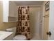 Functional bathroom with a toilet, sink, and shower, complete with a shower curtain at 25275 Rampart Blvd # 1203, Punta Gorda, FL 33983