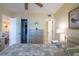 Relaxing bedroom with view to the living room, features a ceiling fan and a calming color palette at 25275 Rampart Blvd # 1203, Punta Gorda, FL 33983