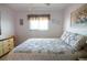 Comfortable bedroom featuring a double bed, neutral tones, ceiling fan and a window for natural light at 25275 Rampart Blvd # 1203, Punta Gorda, FL 33983