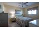 Cozy bedroom featuring a double bed, neutral tones, ceiling fan and a window for natural light at 25275 Rampart Blvd # 1203, Punta Gorda, FL 33983
