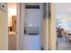Efficient laundry area with stacked washer and dryer, conveniently located near a bathroom at 25275 Rampart Blvd # 1203, Punta Gorda, FL 33983