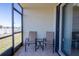 Cozy screened patio features seating, perfect for enjoying the lake view and fresh air at 25275 Rampart Blvd # 1203, Punta Gorda, FL 33983