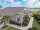 Aerial view of a beautiful home showcasing a well-manicured lawn, mature trees, and a tranquil lake nearby at 2912 Fiddlers Bnd, Palmetto, FL 34221