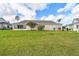 Spacious backyard featuring a lush lawn, mature trees, and a screened-in porch, perfect for outdoor enjoyment at 2912 Fiddlers Bnd, Palmetto, FL 34221