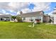 Well-maintained backyard with lush green grass, mature landscaping, and a cozy patio, perfect for relaxing outdoors at 2912 Fiddlers Bnd, Palmetto, FL 34221